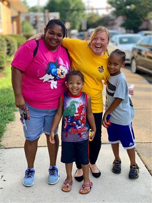 Parent, students and teacher celebrating school. 